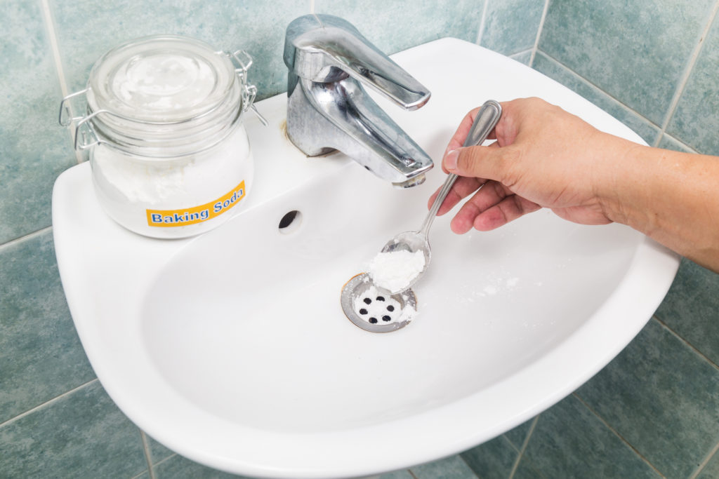 Baking soda poured to unclog drainage system at home