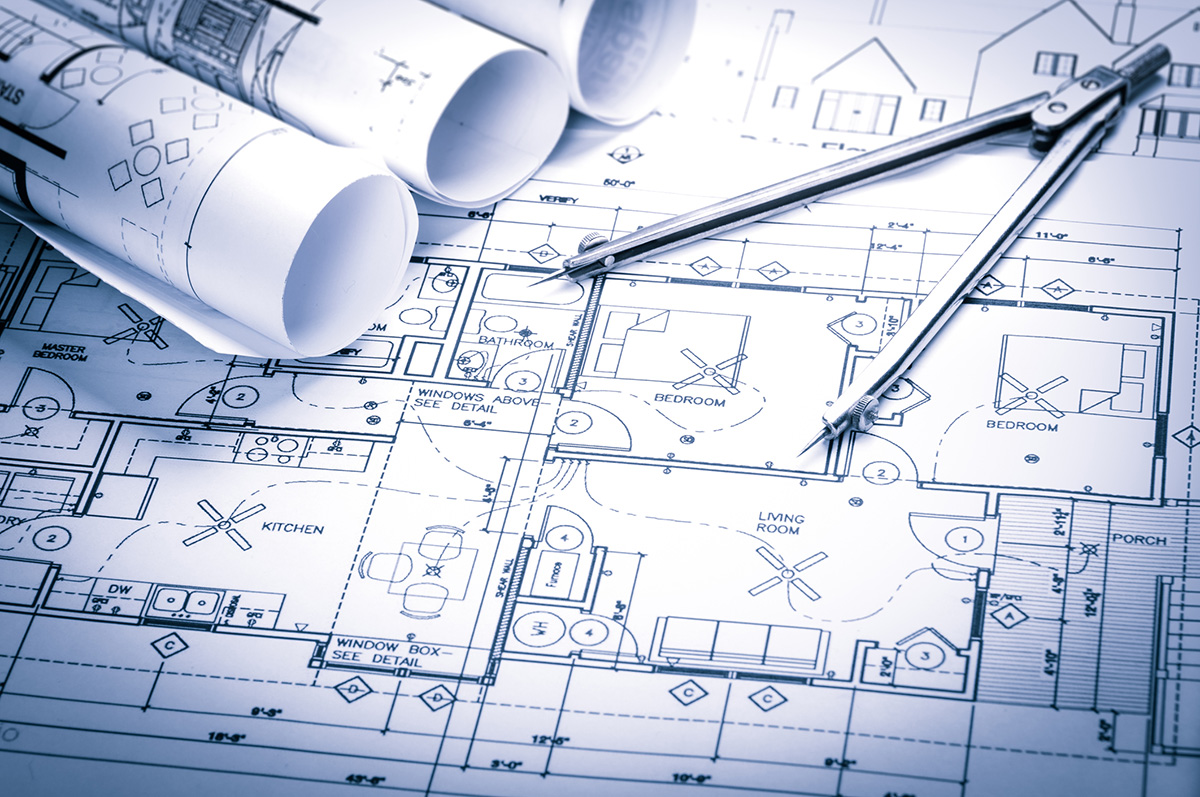 Architecture concept with drawing compass on blueprints.