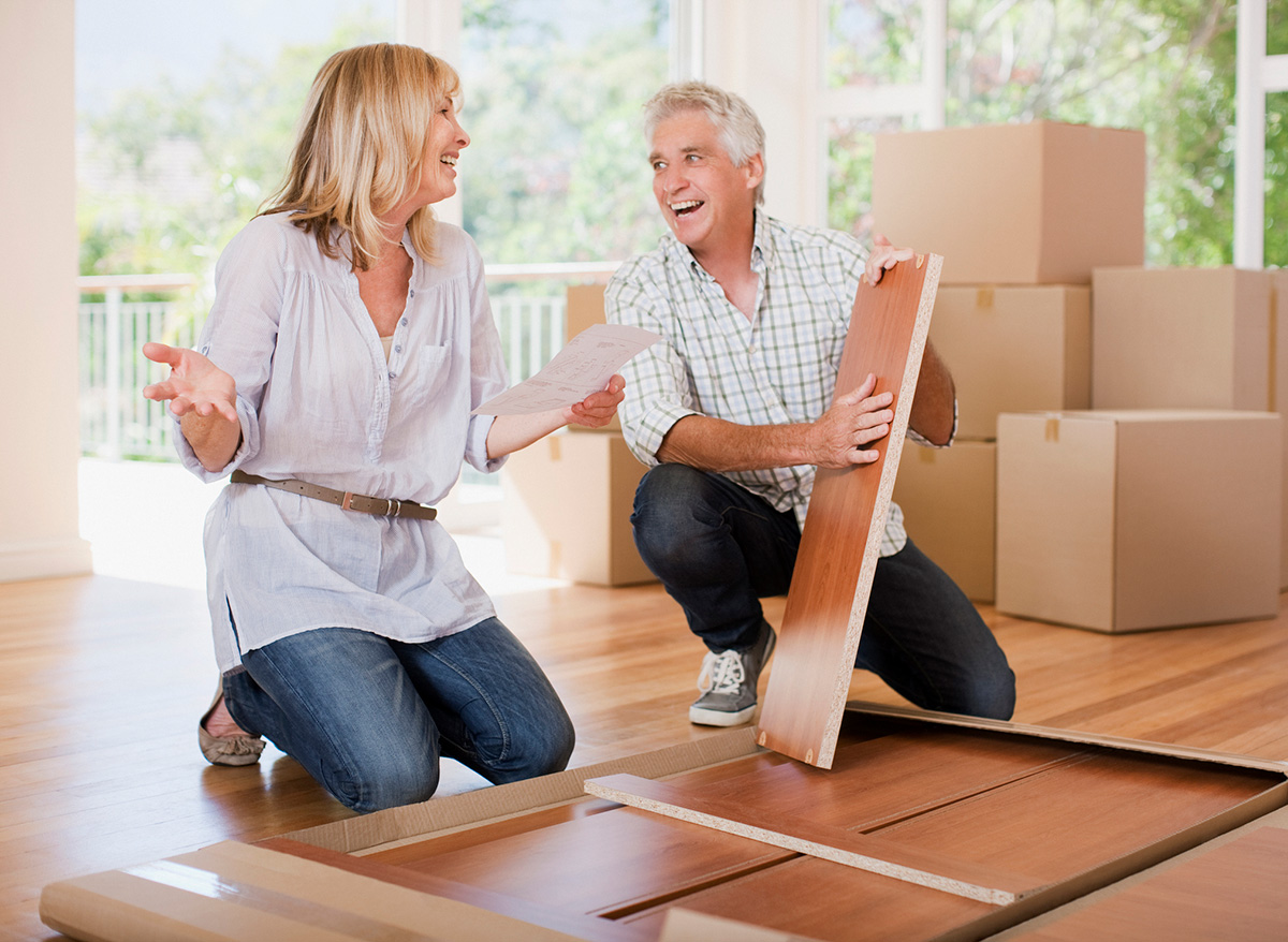 Couple unpacking boxes in new house